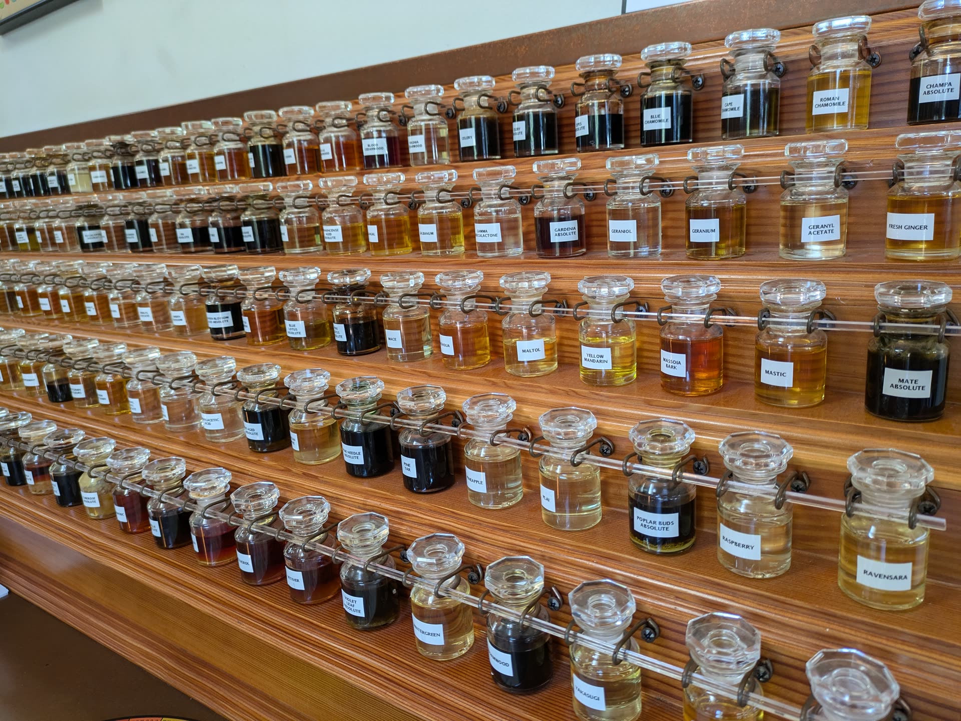 The perfumer's organ: rows of raw materials the house composes from.